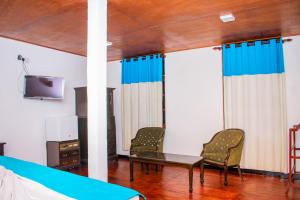 a room with two chairs and a table and a tv at Sarada Beach Resort Yala in Tissamaharama