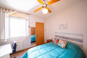 a bedroom with a bed and a ceiling fan at Atocha Center in Madrid