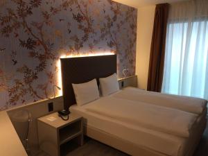 Ліжко або ліжка в номері Hotel Internazionale Bellinzona