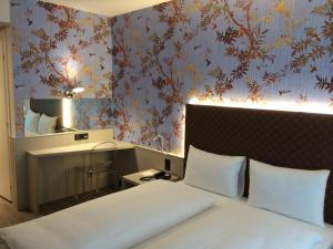 Ліжко або ліжка в номері Hotel Internazionale Bellinzona