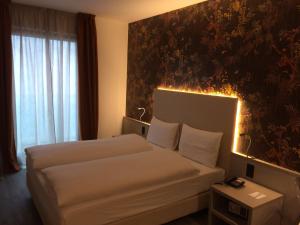 Ліжко або ліжка в номері Hotel Internazionale Bellinzona
