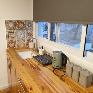 a kitchen counter with a sink and a window at Moonlight Suite Arad צימר אור הירח, ערד in Arad
