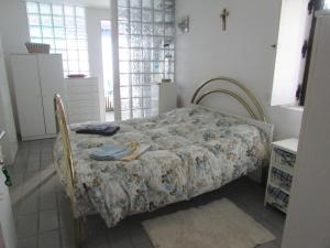 a bedroom with a bed with a floral bedspread at La Terrazza Mombarone in Asti