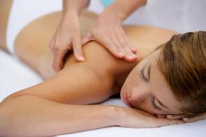 a woman is getting a massage in a spa at Hotel Giulio Cesare in Rimini