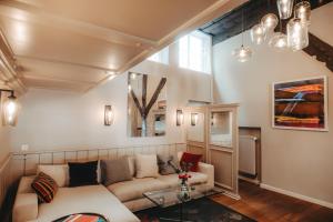 a living room with a couch and a table at Hotel zum Heidkrug & Café Lil in Lüneburg