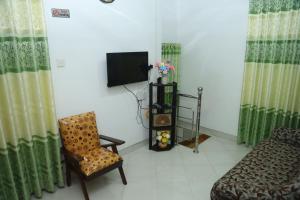 a living room with a couch and a tv and a chair at FOREST VIEW HOME STAY in Anuradhapura