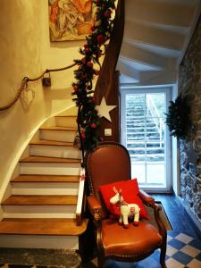 a stairway with a rocking chair with a red pillow at Villers la villA in Villers-la-Ville