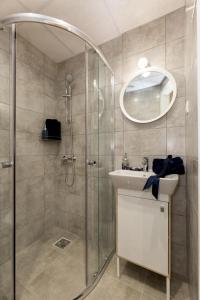 a bathroom with a shower and a sink and a mirror at Budapest Holidays Fashion in Budapest