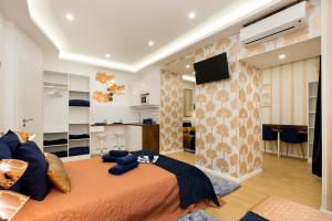a bedroom with a large bed and a living room at Budapest Holidays Fashion in Budapest