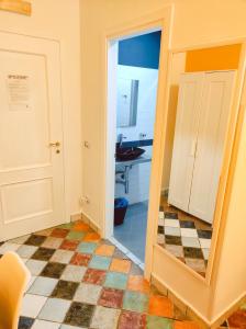 a bathroom with a mirror and a checkered floor at Firenze32 in Naples