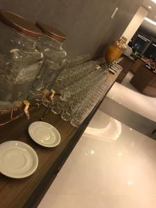 a counter with glasses and plates on a table at Laghetto Golden Resort Gramado 439 in Gramado