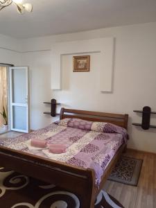 a bedroom with a bed with a purple comforter at Карпатські ночі in Yaremche