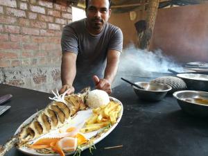a man standing in front of a plate of food at Magic World in Palolem +67 photos