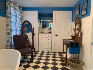 a room with a table and a chair and a desk at THE YORK HOUSE in Fort Erie