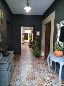 a kitchen with a tile floor and a hallway at Casa rural el Burro in Agüimes