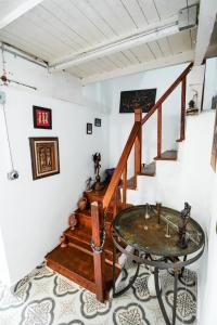 a room with a table and a staircase at Grape Island Bozcaada Guest House in Canakkale