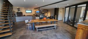 a kitchen and dining room with a table and chairs at Bel Aujourd'hui Spa Sauna in Cordelle