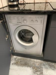 a white washing machine in a utility room at Уютная квартира возле метро 23 Августа in Kharkiv