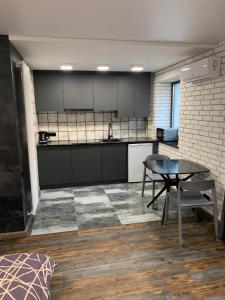 a kitchen with a table and a counter top at Уютная квартира возле метро 23 Августа in Kharkiv