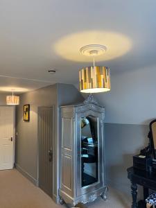 a room with a mirror and a chandelier at The White House Hotel in Newquay
