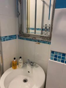 a bathroom with a white sink and a mirror at The White House Hotel in Newquay