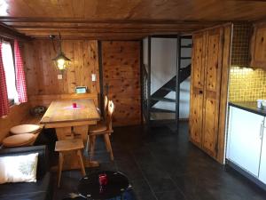 a room with a wooden table and a bunk bed at Chalet Edith Oberems in Oberems