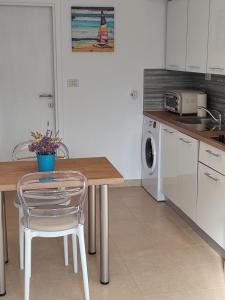 a kitchen with a table and a chair in it at Apartman Studio Lu in Nerezine