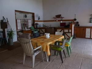 a dining room with a table and chairs at La Sylreine in Crottet