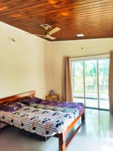 מיטה או מיטות בחדר ב-Ashish Baug Cottage