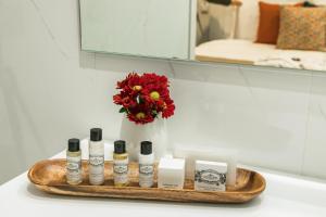 a bathroom counter with a shelf with a vase of flowers at Porto River Infante in Porto