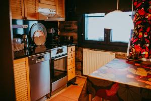 a kitchen with a sink and a stove top oven at Ylämaja - with a stunning view in Ruka
