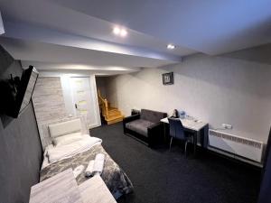a room with a desk and a bed at Villa Hotel Tbilisi in Tbilisi City