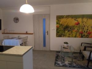 uma cozinha e sala de estar com um quadro na parede em Apartmán GUTINO em Ceská Trebová