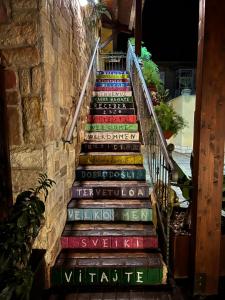 a set of stairs with colorful books on them at B&B Templi e Arte in Villaggio Mosè