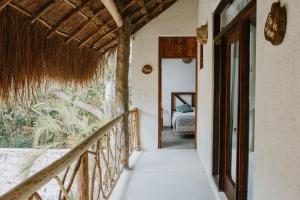 a hallway leading to a room with a bed at Xiknal Cozumel in Cozumel