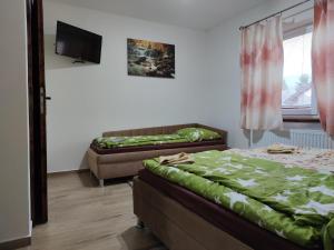 A bed or beds in a room at András penzión