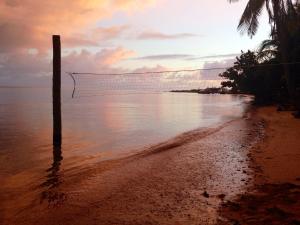 a volleyball net on a beach with the ocean at Funky Fish Beach & Surf Resort in Malolo