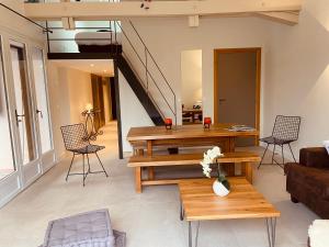 a living room with wooden tables and chairs at Chalet Pleine Vue & Spa in Chamonix