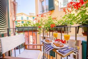 a table with food and drinks on a balcony at SoleMare in Monterosso al Mare