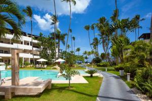 a pool at the resort with palm trees at Stunning 2-Bed Apartment in Las Terrenas in Las Terrenas