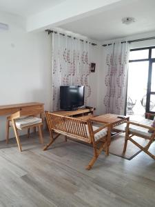 a living room with wooden furniture and a flat screen tv at Villa Trochetia in La Gaulette