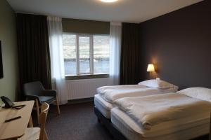 Rúm í herbergi á Basalt Hotel