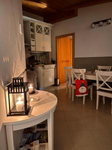 a kitchen with a table with a candle and chairs at Casa Nina in Andalo