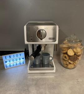 a coffee maker sitting on a counter next to a container of bread at Apartmán Šantovka in Olomouc +8 photos