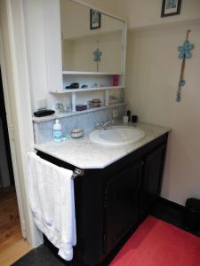 a bathroom with a sink and a mirror and towels at hoeve onder de eik in Jabbeke