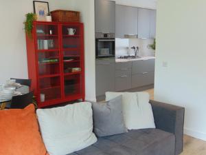 a living room with a couch and a kitchen at Driftwood, Donaghadee in Donaghadee