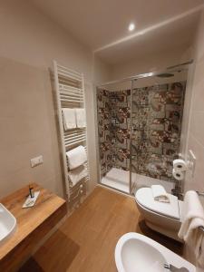 a bathroom with a shower and a toilet and a sink at La Lampara in Sirmione