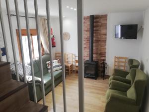 a living room with a couch and a stove at Casa Río Quentar in Quéntar