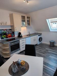 a small kitchen with a table and a sink at FeWo Ammerbuch in Ammerbuch