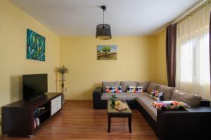 a living room with a couch and a tv at Apartmen Karmen 2 in Trogir